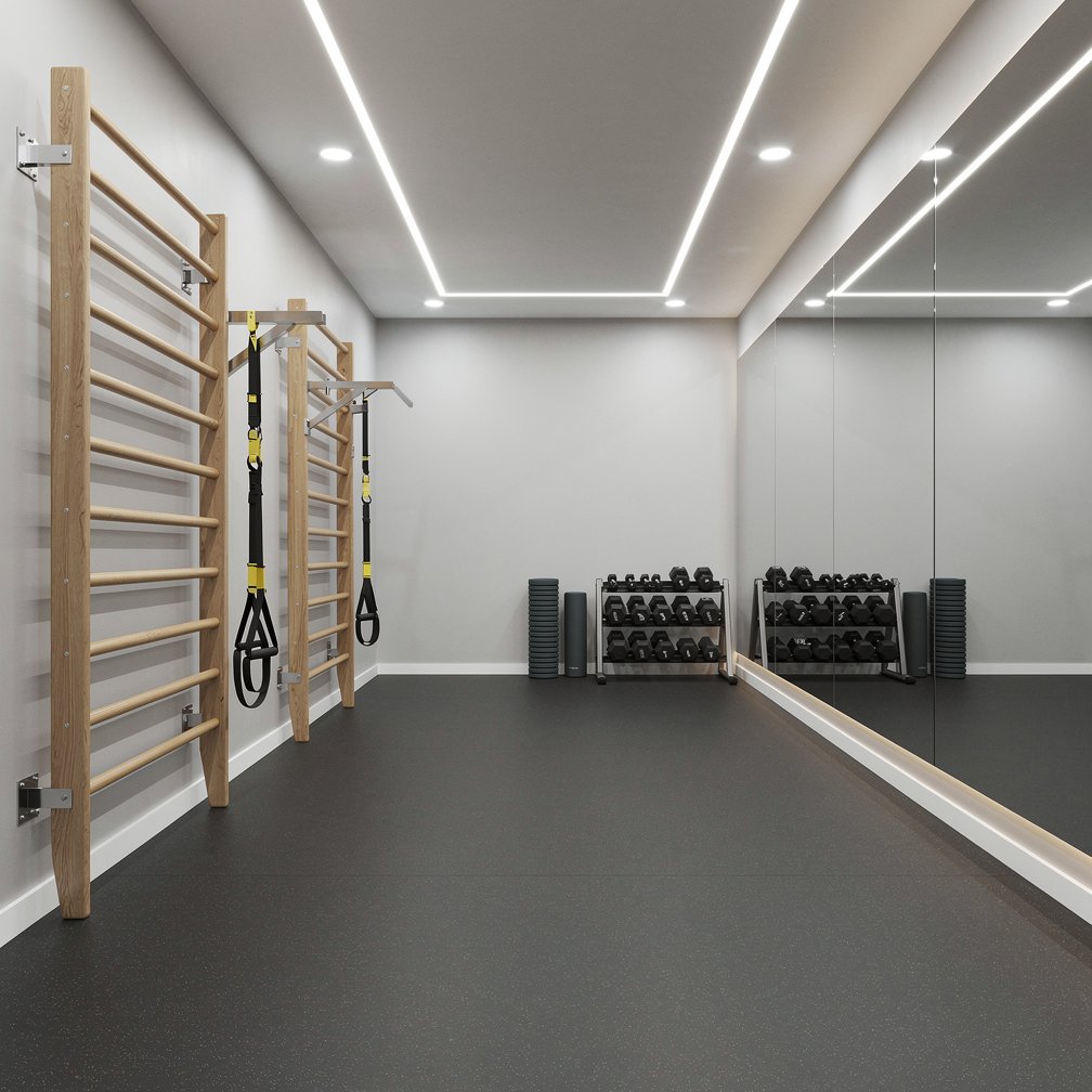 Small modern gym interior with mirrors and wall bars, bright lighting, sports floor.